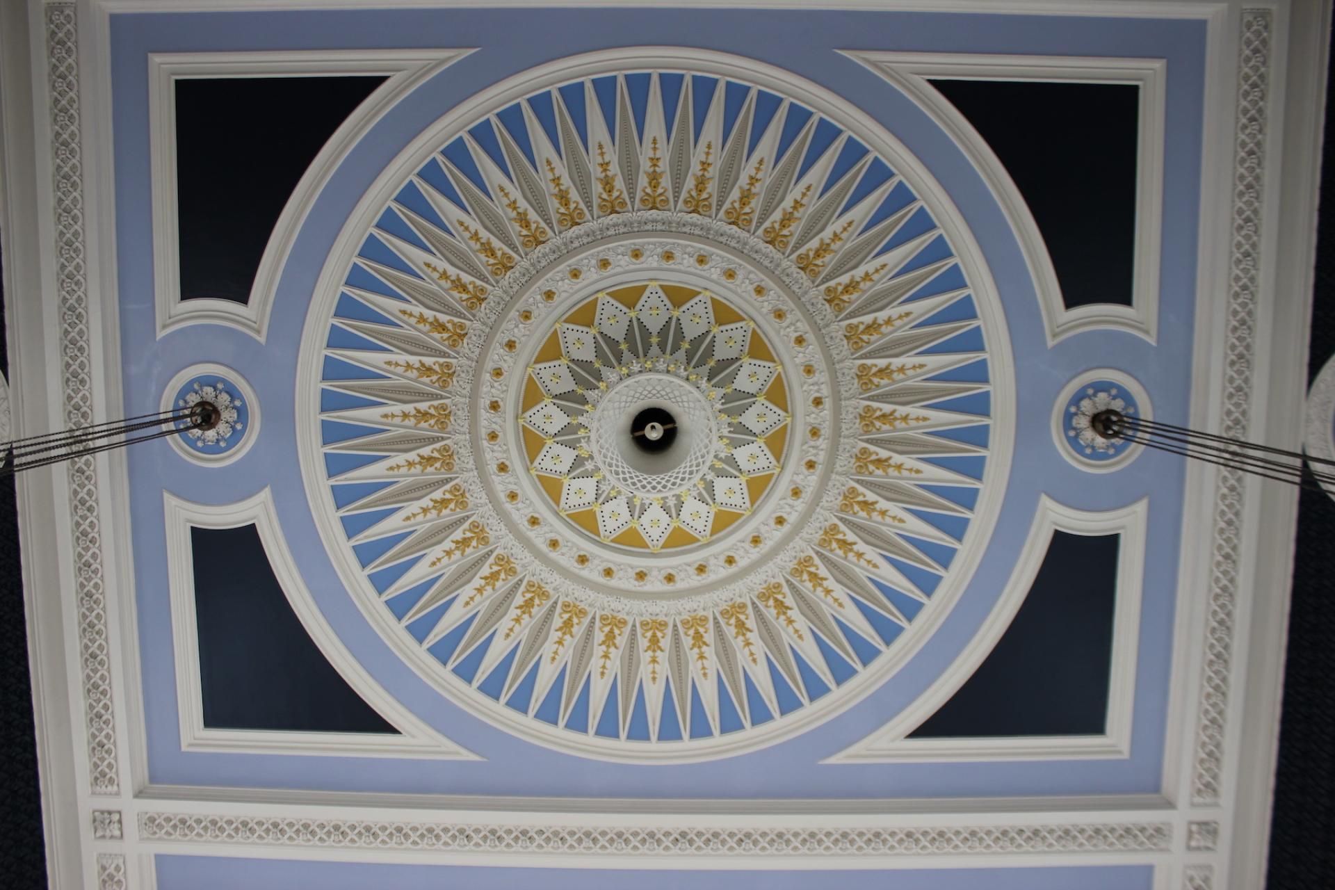 Renovated ceiling design of Todmorden Town Hall's ballroom featuring intricate patterns in blue and gold.