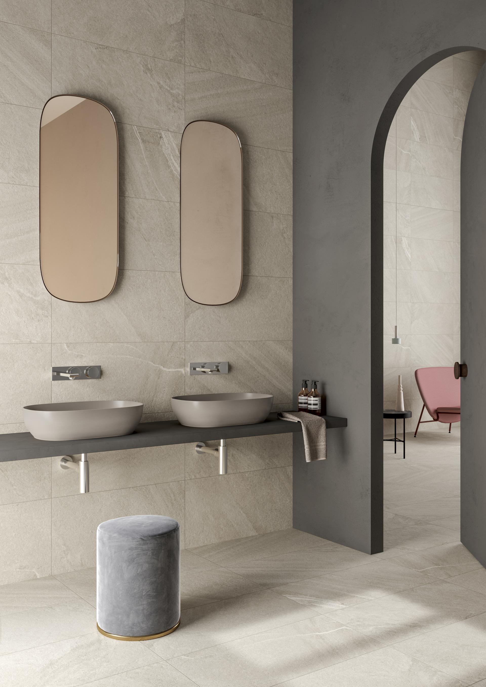 Elegant bathroom design featuring textured tiles, modern sinks, mirrors, and stylish decor showcased by VitrA at Cersaie 2018.
