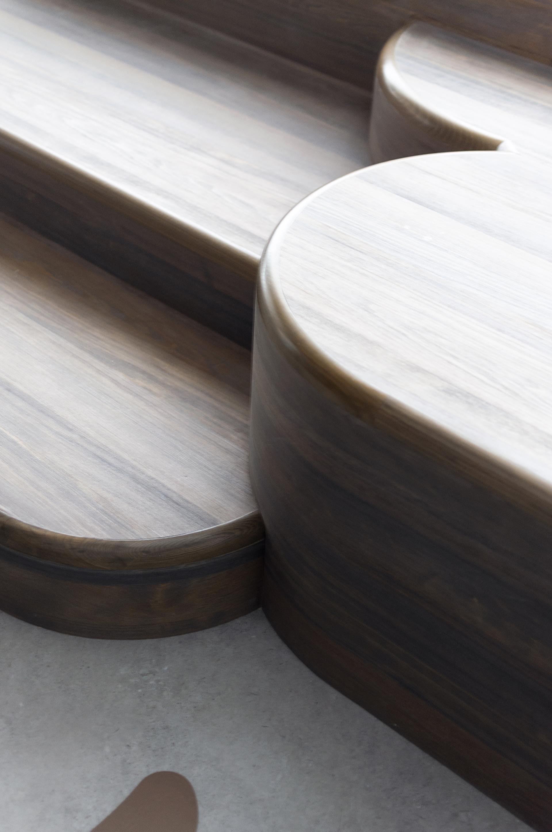 Sculptural wooden seating integrated into a paediatric clinic, enhancing a playful and welcoming wellbeing environment.