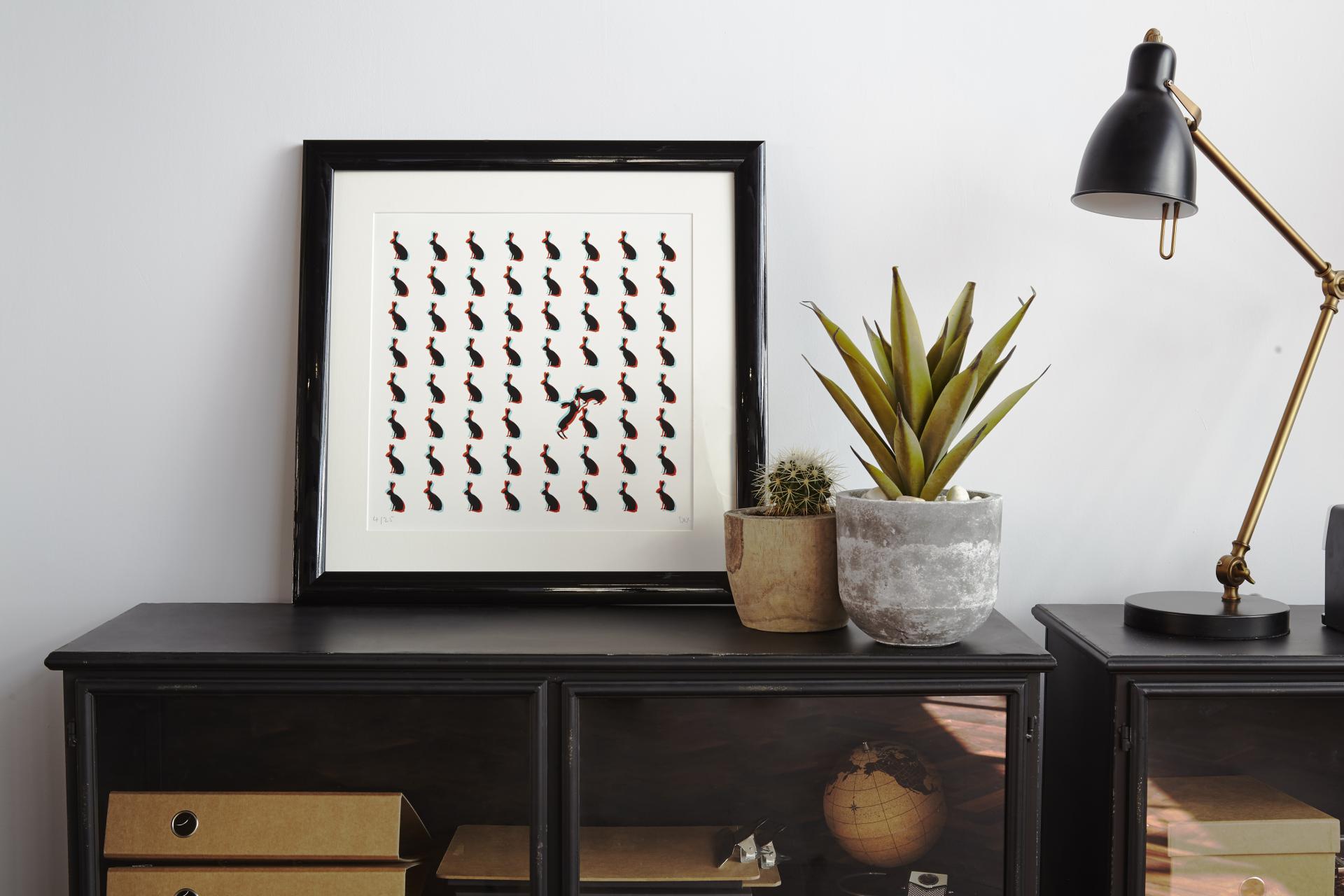 Chic loft-style office decor featuring a framed artwork, plants, and stylish lighting, highlighting Run For The Hills design.