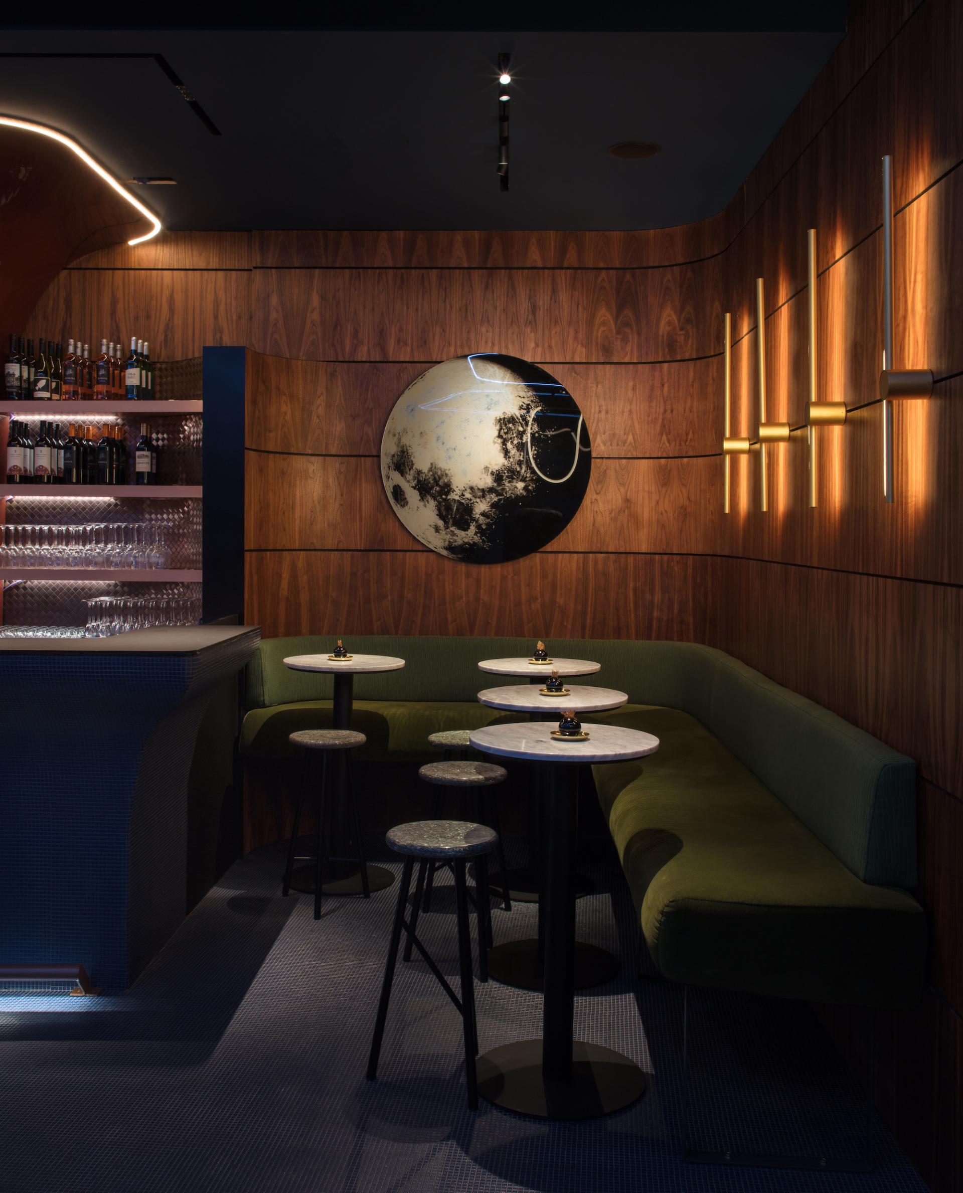 Elegant interior of M'Arks Sky Bar featuring a stylish bar, cozy seating, and artistic decor in London.