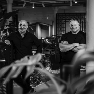 Darren Clanford and Michael Rogan celebrate six months of collaboration at Material Source Studio in a vibrant setting.
