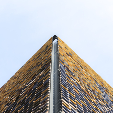 Architectural design featuring vibrant Spanish ceramics in a striking modern building, showcasing innovative use of tile in construction.