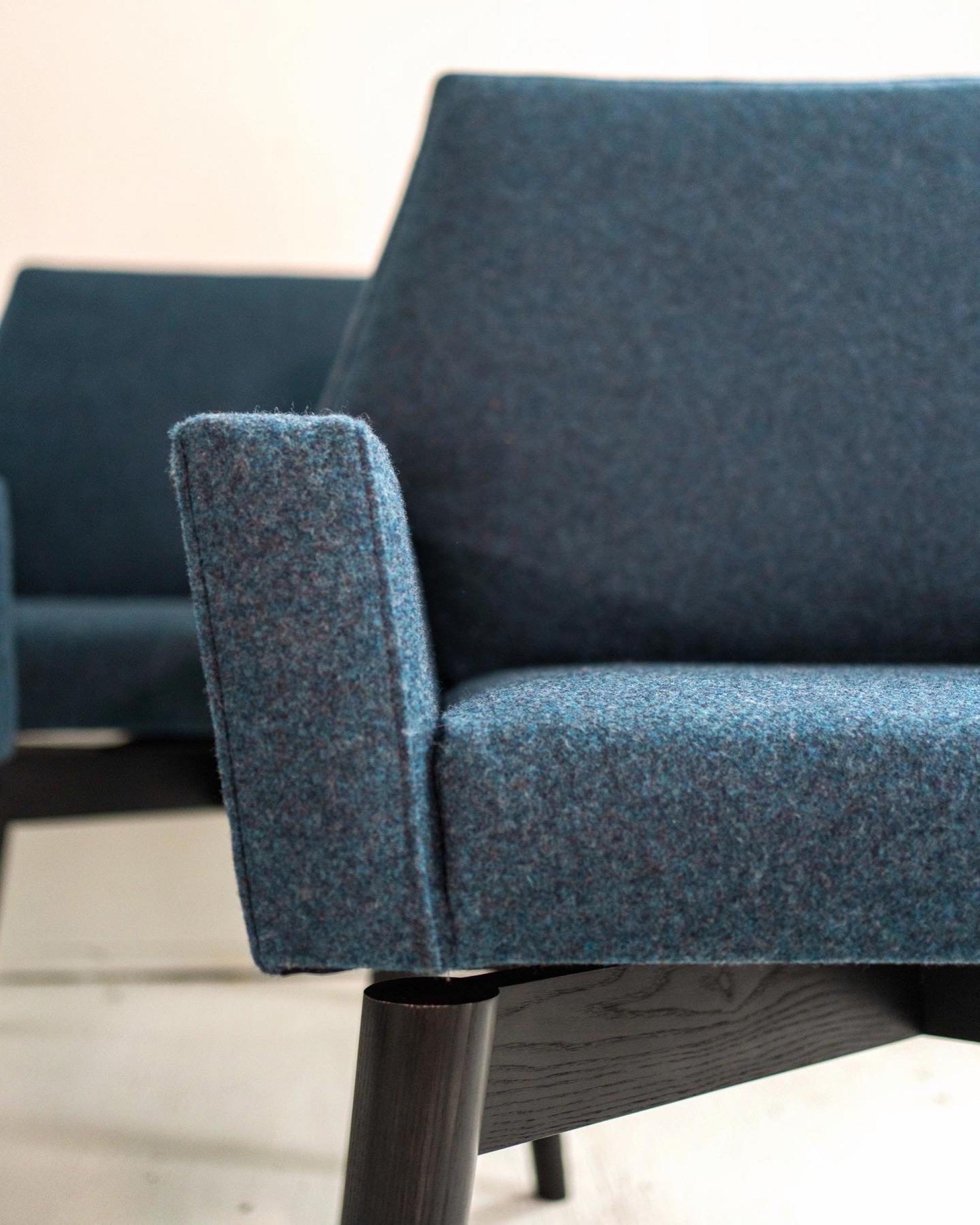 Contemporary blue-fabric chair designed by Maggie Jo Sanderson, showcasing modern Midwest furniture design aesthetics.