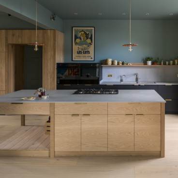 Modern kitchen featuring Caesarstone's Airy Concrete countertop, wooden cabinetry, and stylish decor in a coastal Edinburgh home.