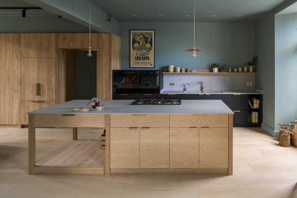 Modern kitchen featuring Caesarstone's Airy Concrete countertop, wooden cabinetry, and stylish decor in a coastal Edinburgh home.