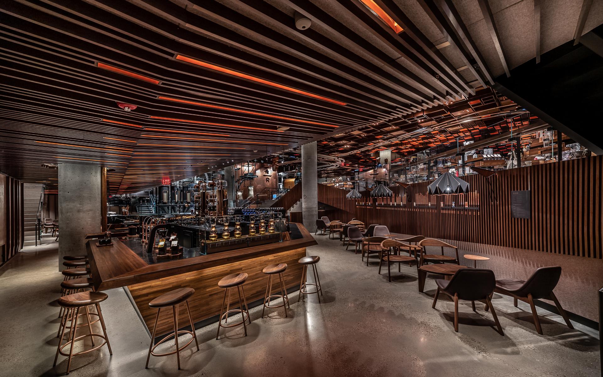 Luxurious interior of the new Starbucks Reserve Roastery in New York’s Meatpacking District, featuring elegant seating and lighting.