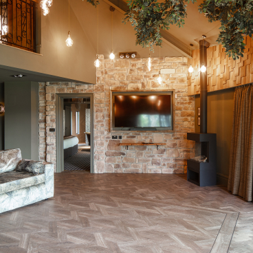 Stylish interior of the Dove Treehouse featuring natural wood accents, stone walls, and cozy lighting fixtures.