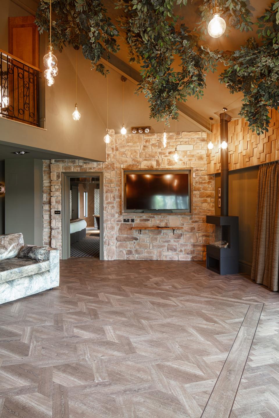 Stylish interior of the Dove Treehouse featuring natural wood accents, stone walls, and cozy lighting fixtures.