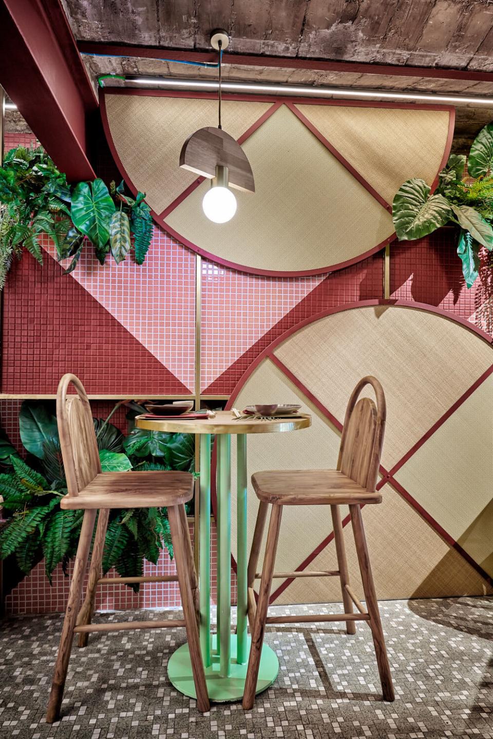 Tropical-inspired dining space featuring vibrant textures, greenery, and contemporary Japanese-Brazilian design elements at Kaikaya restaurant.