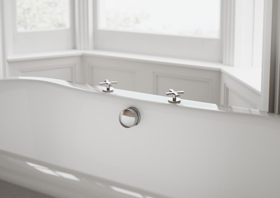 Elegant freestanding bathtub with vintage-style taps, highlighting timeless bathroom design inspired by classic aesthetics.