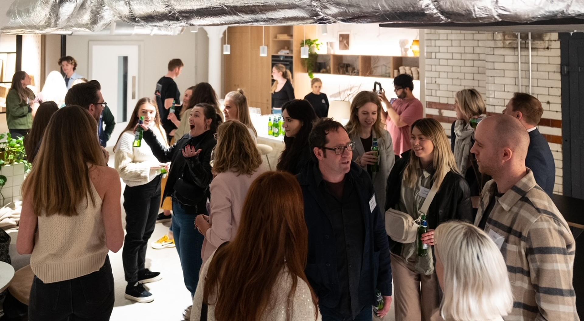 Guests engaging and networking at the Material Source Studio event on hospitality branding and experiences.