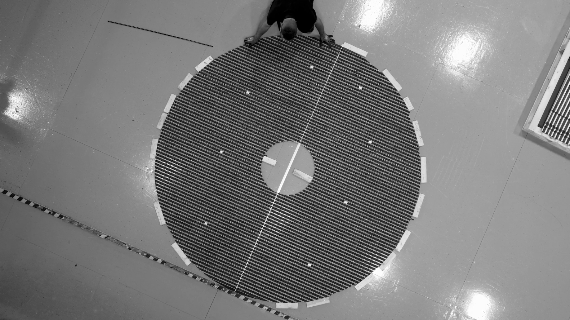 Worker adjusts a circular mat during the 100-year celebration of Forbo's sustainable flooring production in Telford.