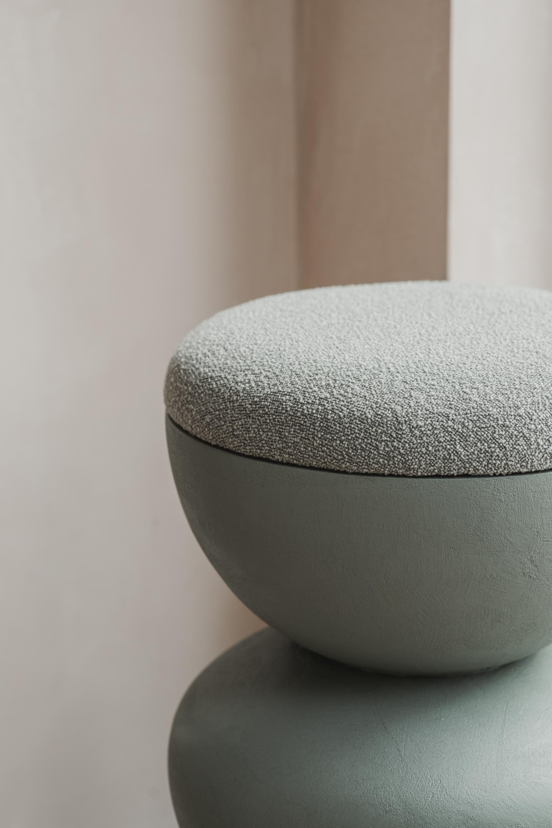 Curvaceous stool with a soft, textured cushion, inspired by Hampstead Ladies' Pond, showcasing modern furniture design.