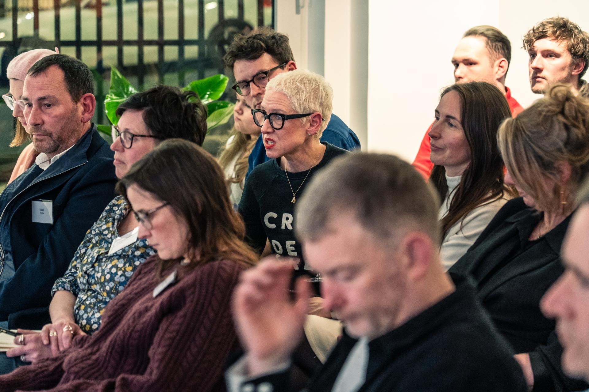 Audience engaged in discussion during a sustainable design event at Material Source Studio in Glasgow.