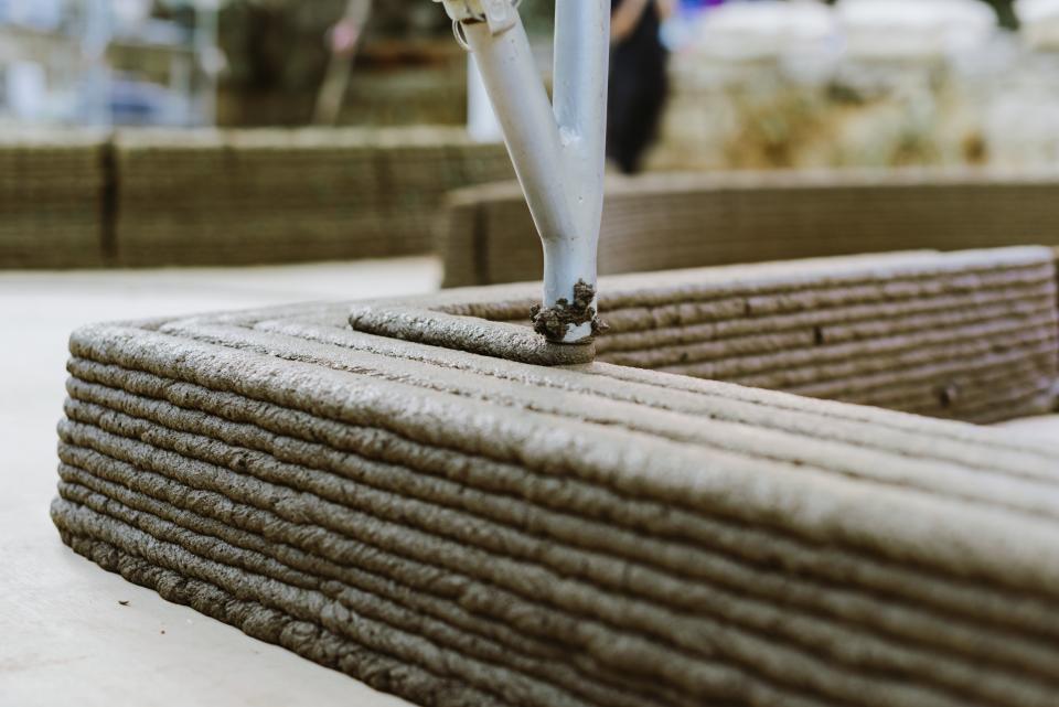 3D printer layering concrete during the 'To Grow a Building' project showcasing innovative construction techniques at Jerusalem Design Week 2022.