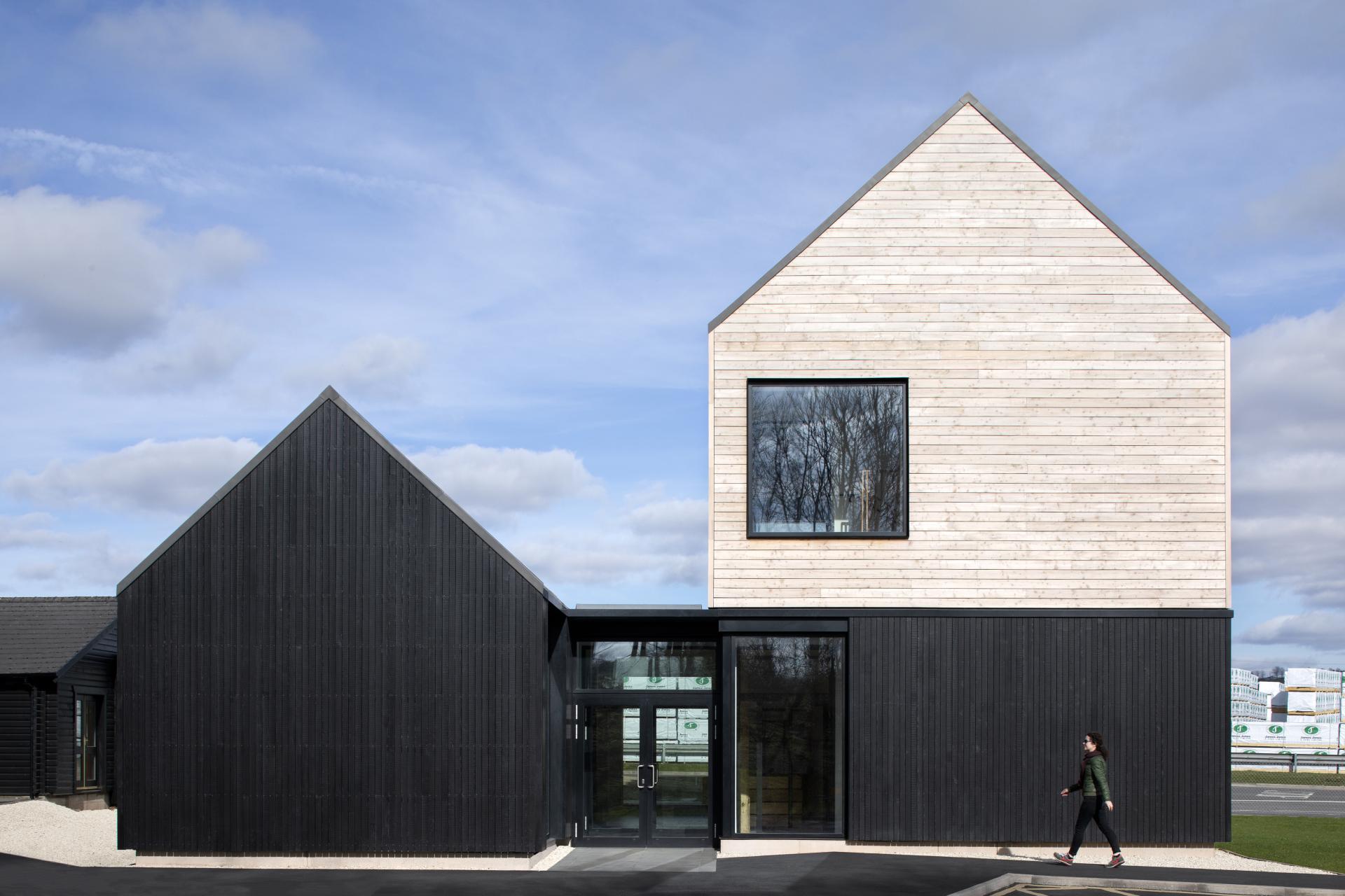 Modern wooden building with distinctive architectural features, nominated for the Wood Awards 2021, showcasing innovative design.