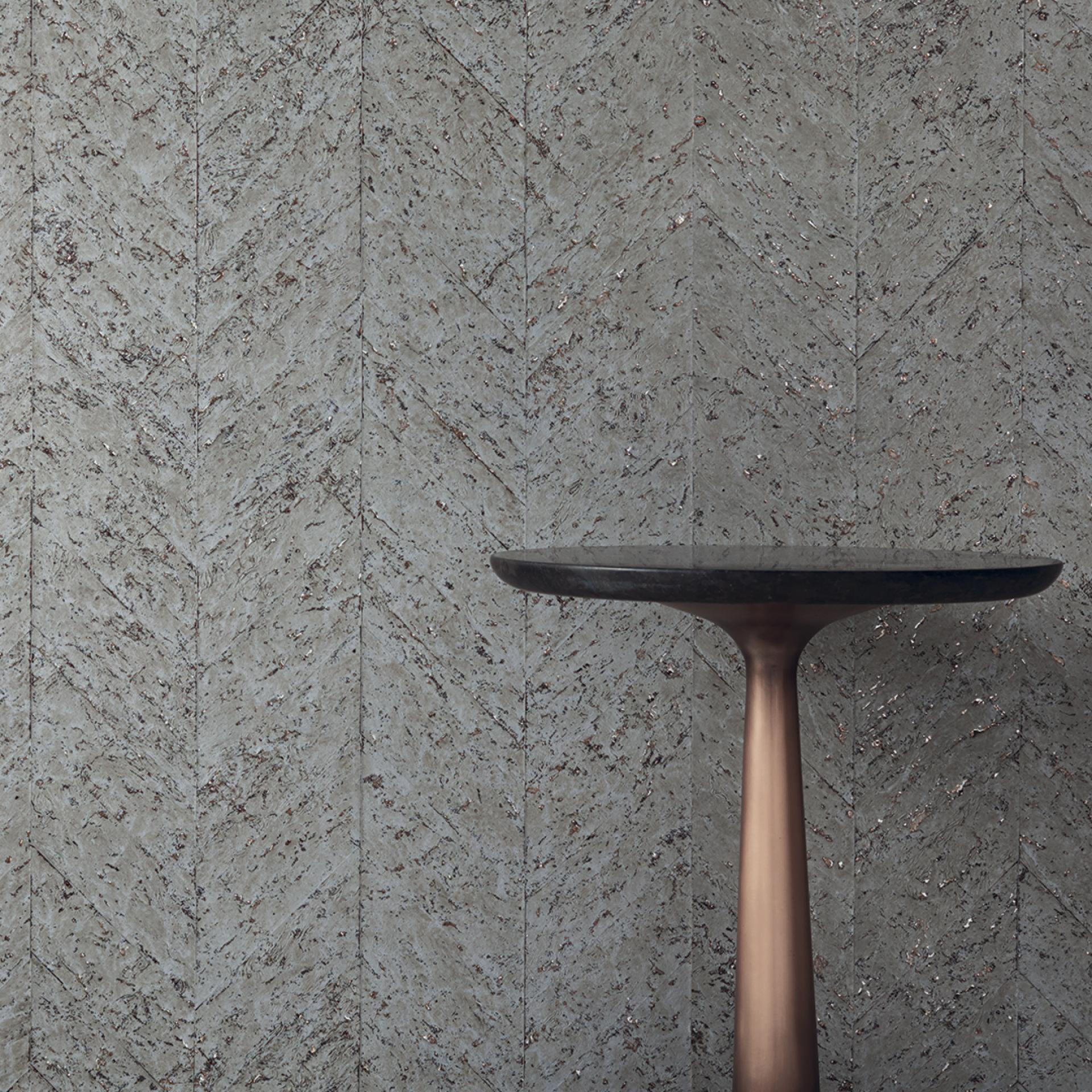 Textured green wallcovering featuring a distinctive herringbone pattern, paired with a modern, minimalist table design.