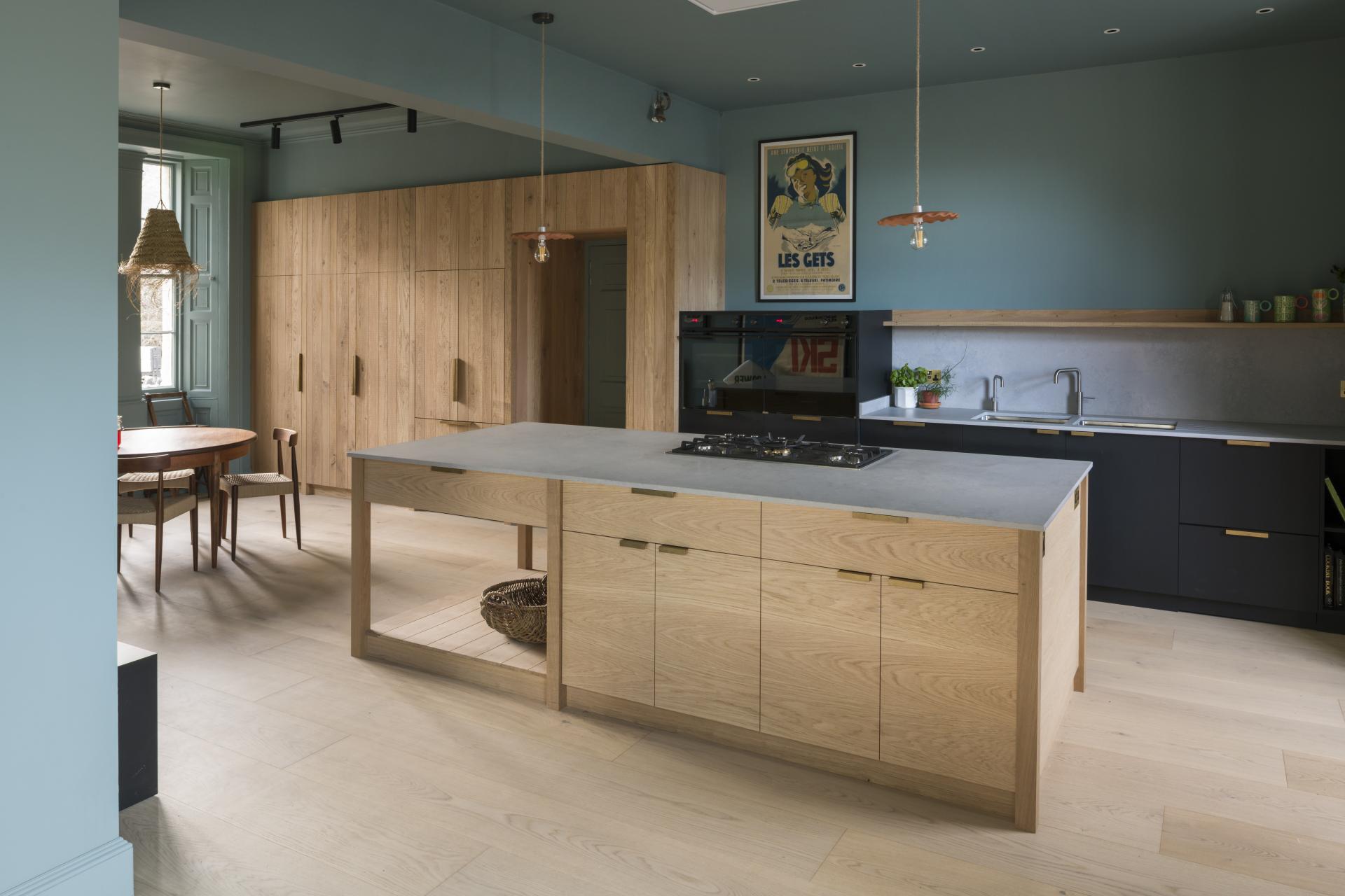 Bright and airy kitchen featuring Caesarstone's 4044 Airy Concrete island and modern wooden cabinetry in Renton Hall.