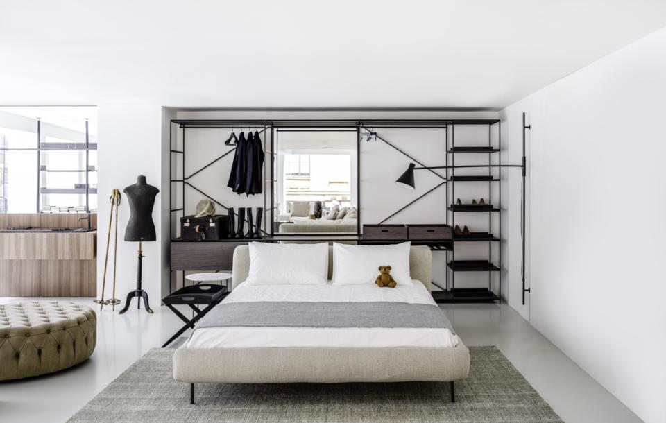 Stylish contemporary bedroom featuring a chic bed, modern storage solutions, and elegant decor, showcasing De Padova's design.