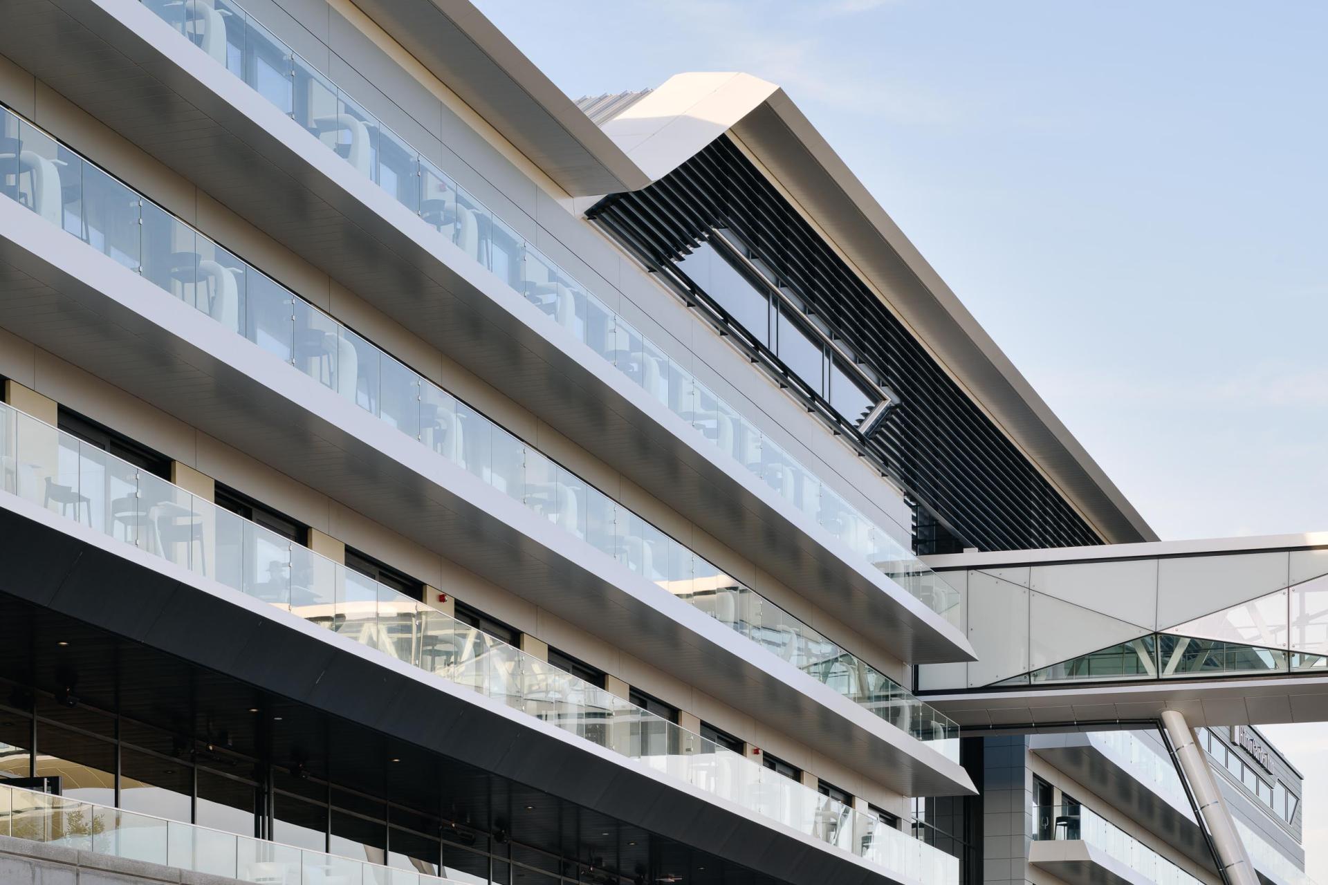 Modern architectural facade of a steel and glass building, emphasizing harmonious design in Liverpool's urban landscape.