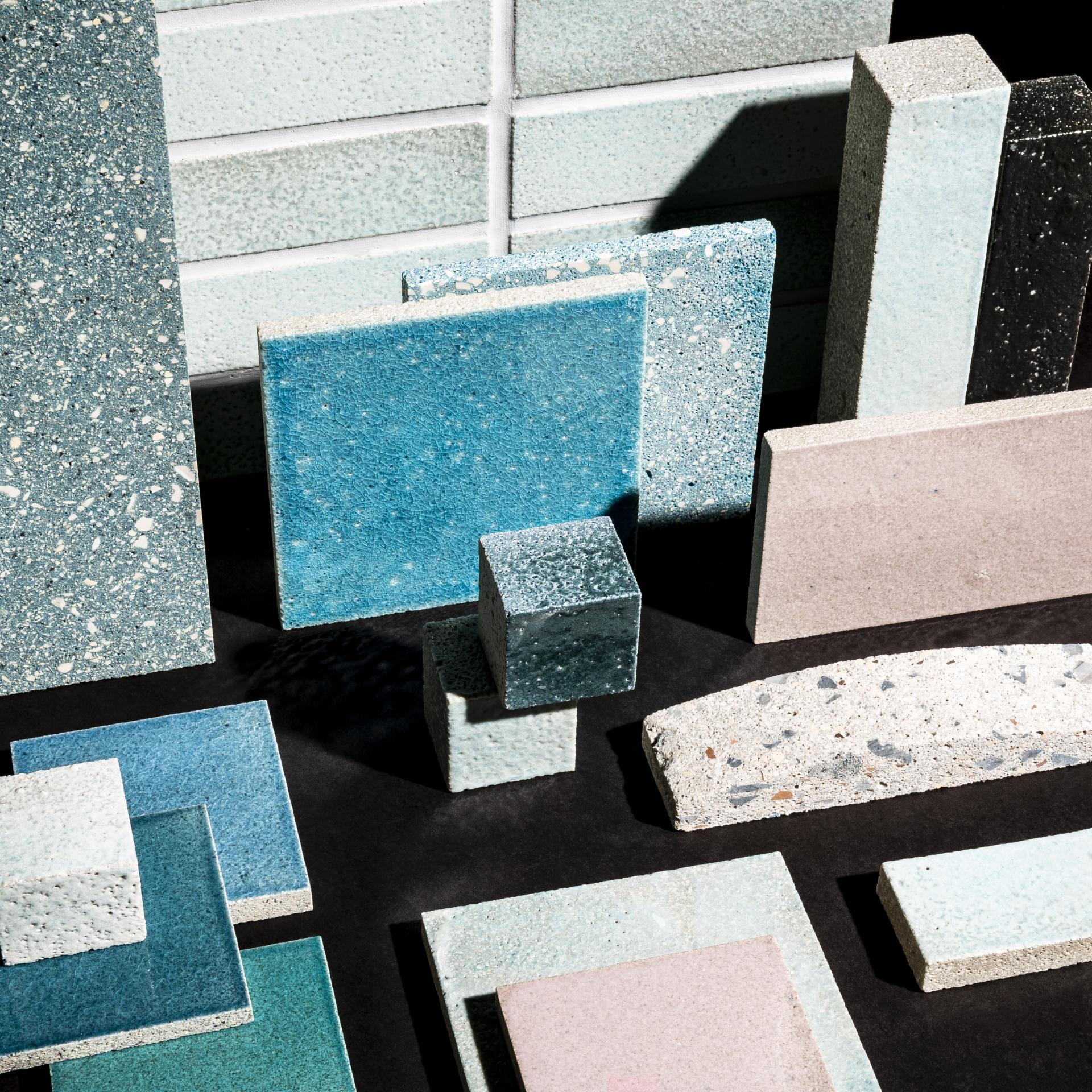 Colorful samples of sustainable materials and surfaces showcased, highlighting Alusid's innovative approach to eco-friendly design.