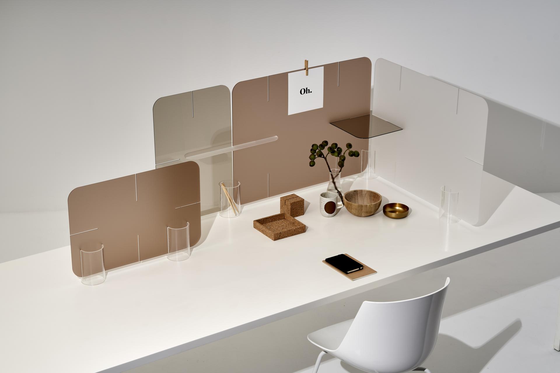 Innovative Clikclax workspace design featuring clear dividers and minimal decor for collaborative environments.