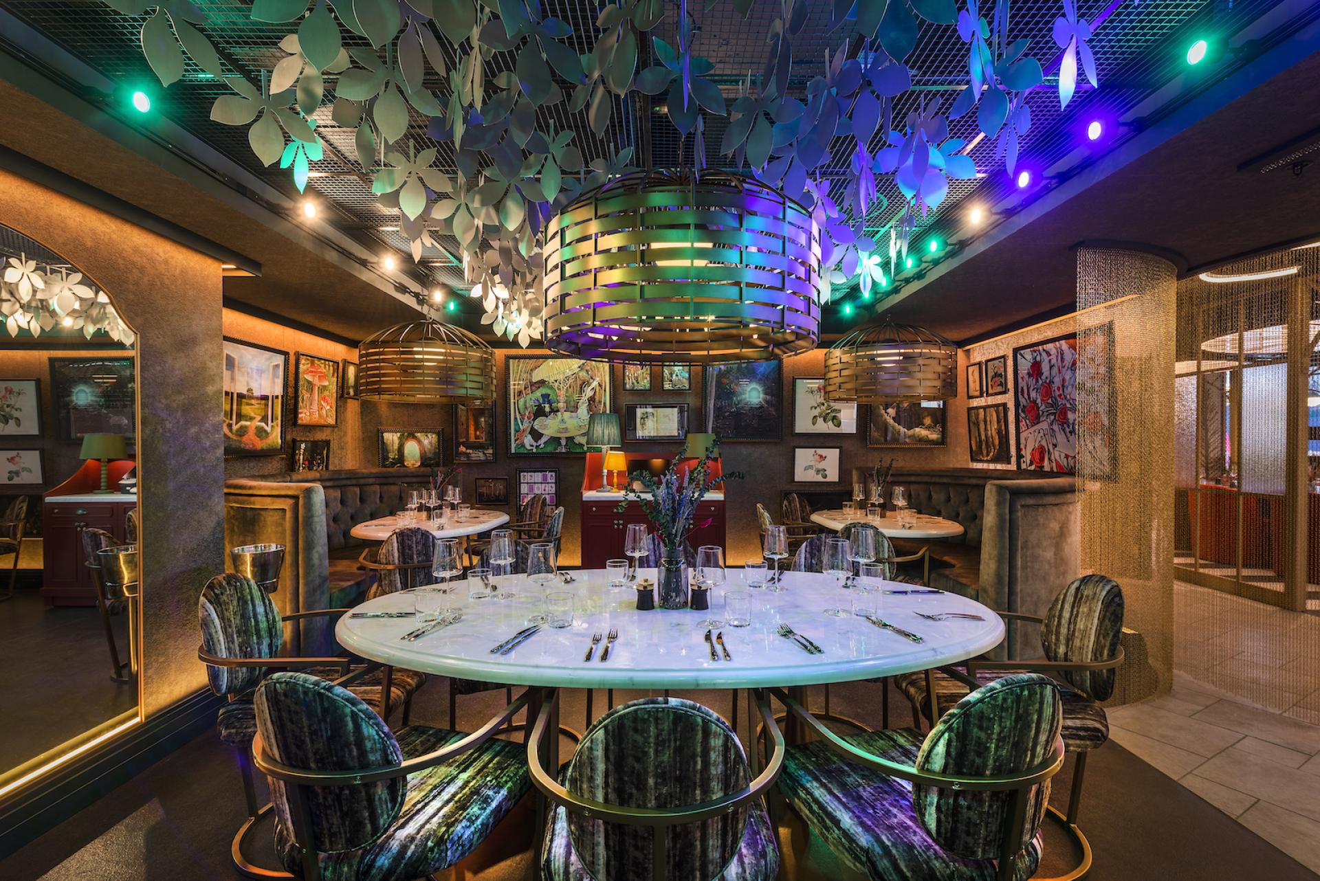 Elegant dining area with colorful decor, intricate lighting, and artistic artwork, embodying a modern Wonderland experience.