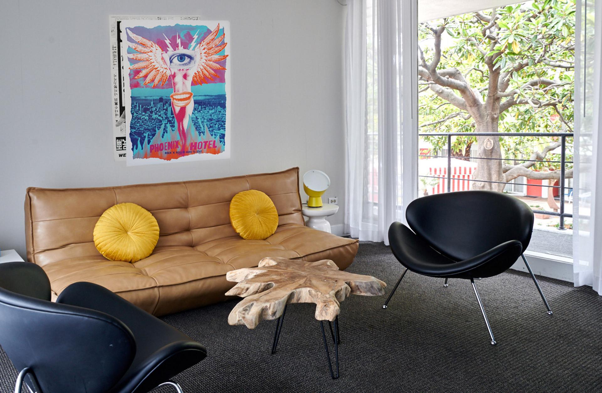 Stylish hotel lobby featuring a modern couch, art display, and natural elements in the Phoenix Hotel, San Francisco.