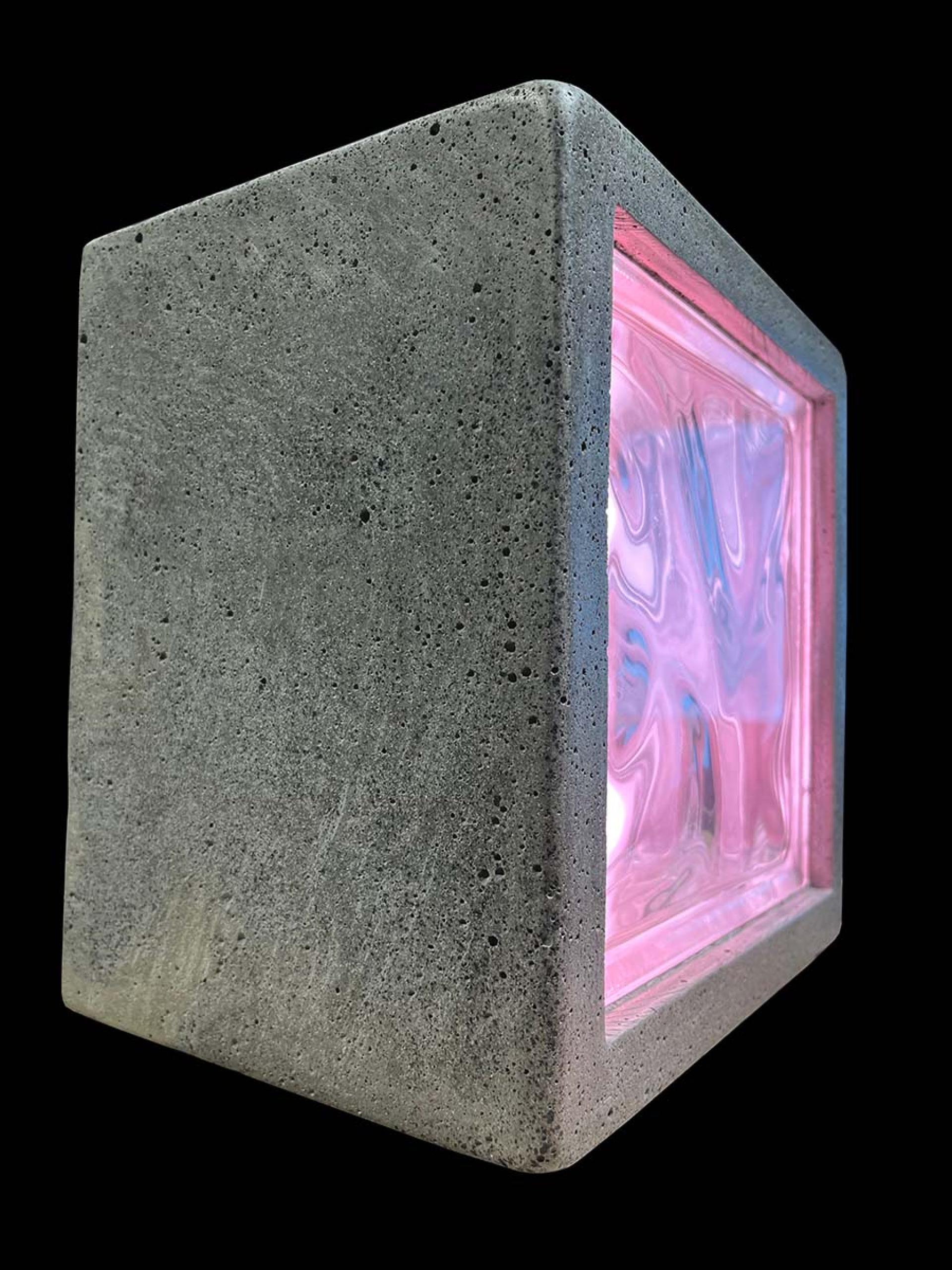 Sculptural biomaterial piece made of concrete and vibrant pink resin, representing innovation in sustainable design.