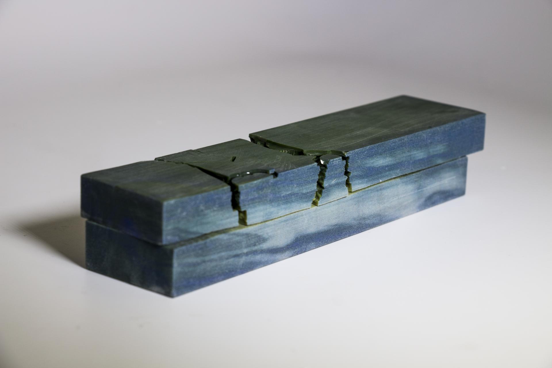 Sustainable alternative to wood featuring two seamless, green-tinted blocks with unique textures and patterns.