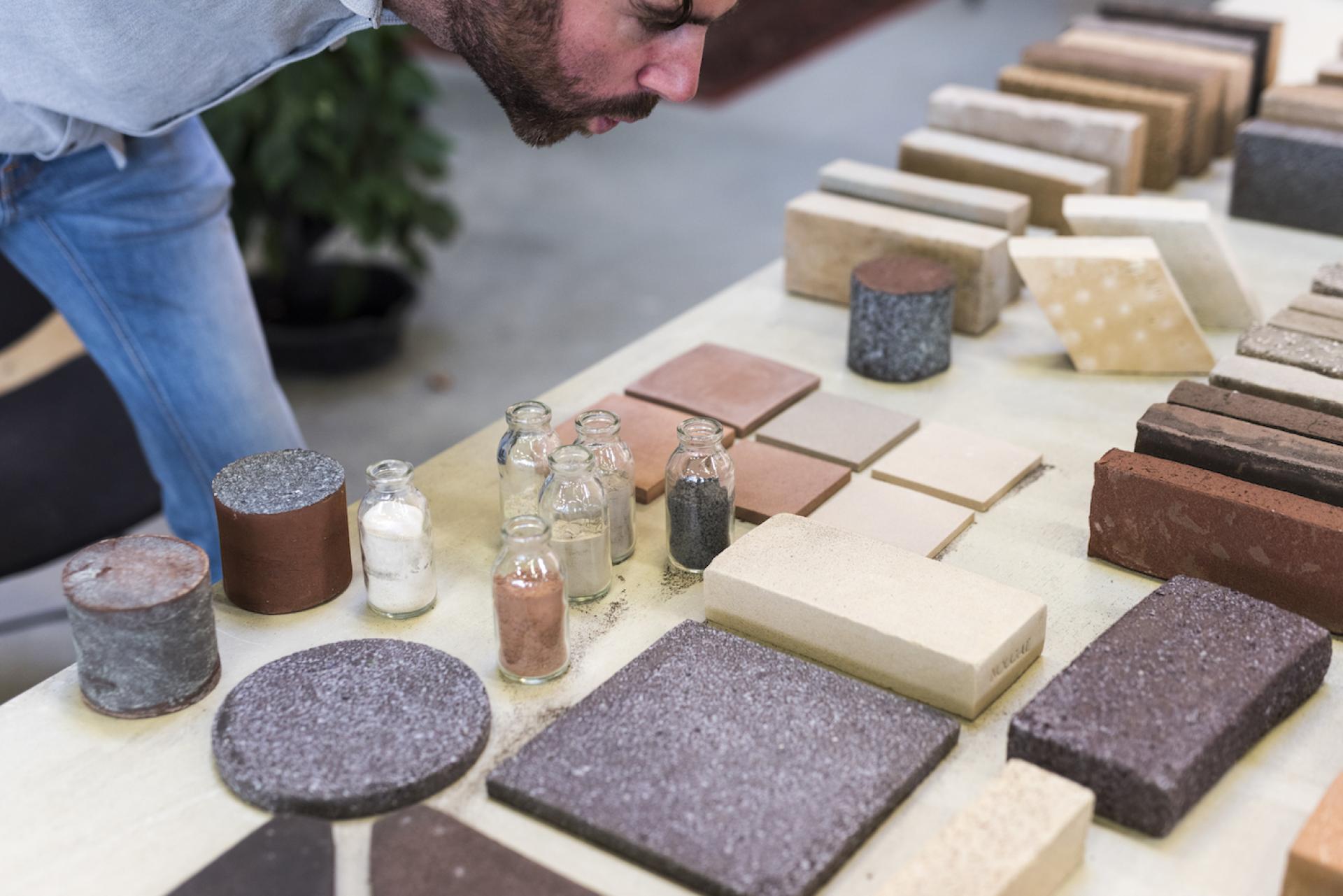 Co-founder Ward Massa examining various sustainable building materials made from recycled waste at StoneCycling.