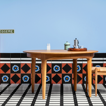 Stylish dining setup featuring a wooden table, a chair, and decorative tiles, showcasing Casa Ceramica's unique design approach.