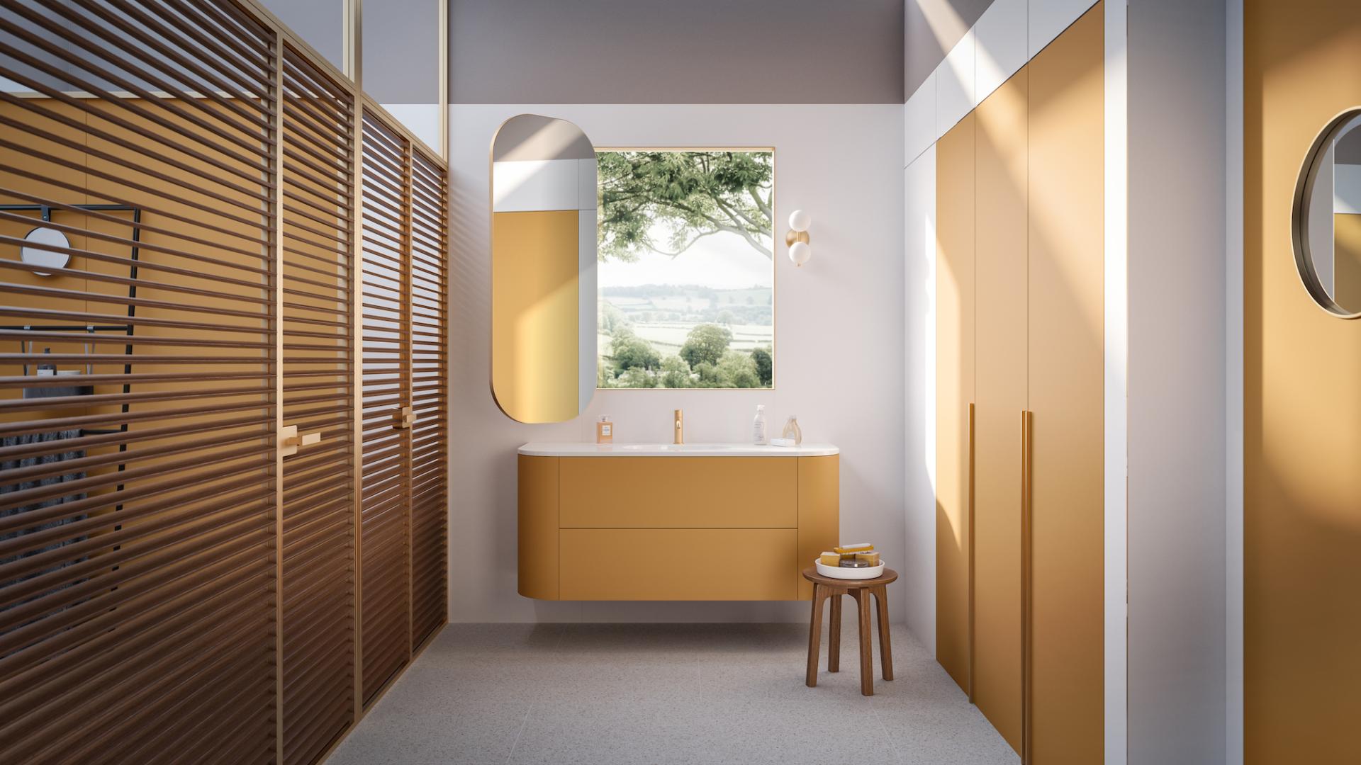 Brightly colored modern bathroom featuring golden cabinetry, a round mirror, and natural light streaming through a window.
