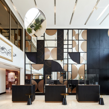 Contemporary hotel lobby design at The8 Hotel in Dubai, featuring geometric art and sleek furnishings by Pallavi Dean.