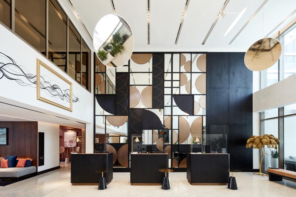 Contemporary hotel lobby design at The8 Hotel in Dubai, featuring geometric art and sleek furnishings by Pallavi Dean.