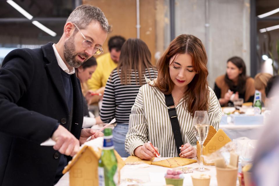 Guests at Material Source Studio creating gingerbread houses during the Community 2024 celebration event in Manchester.