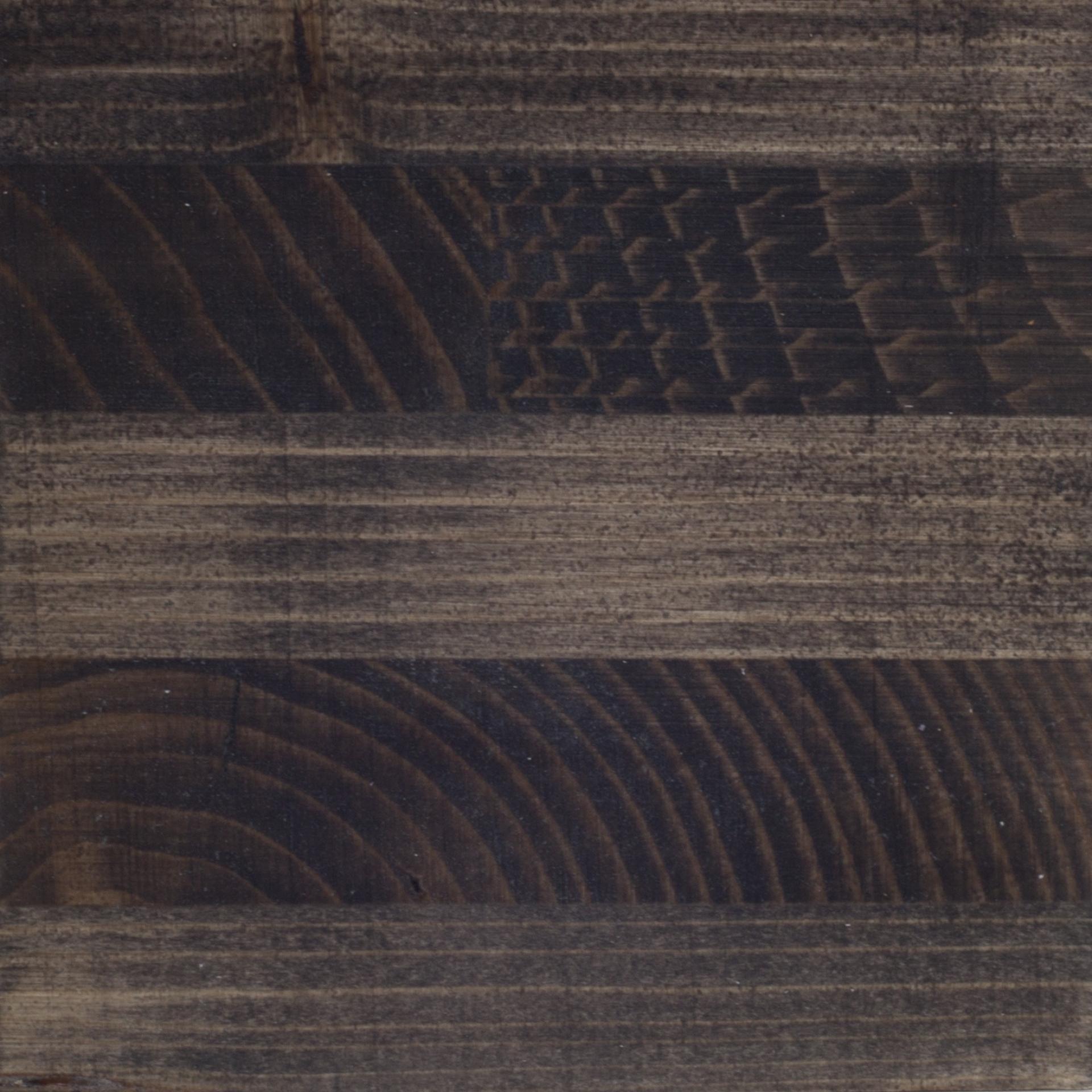 Cross laminated timber texture showcasing a mix of dark and light wood grains, highlighting its architectural potential.