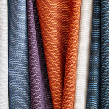 A vibrant display of Supreen performance upholstery fabrics in various colors and textures, showcasing durability and style.
