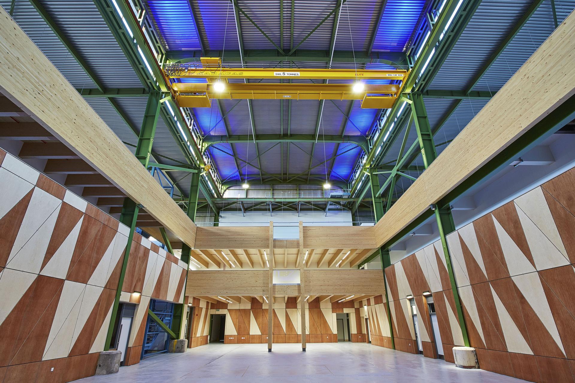 Modern architectural interior featuring wooden structures and geometric wall designs, associated with Maggie's St Barts, 2019 Surface Design Awards.