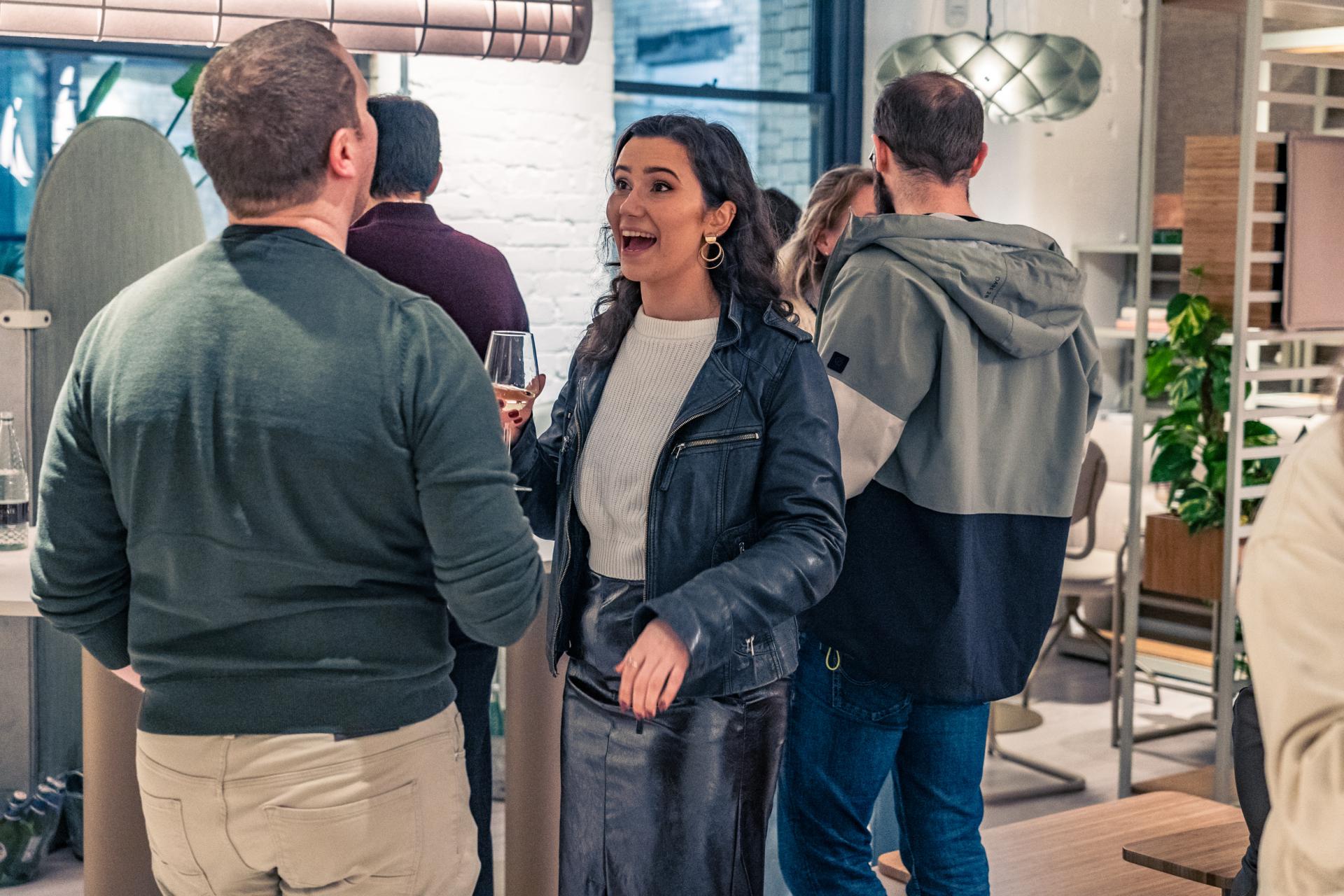 Attendees engage in conversation at an event focused on achieving Net Zero and sustainability goals.