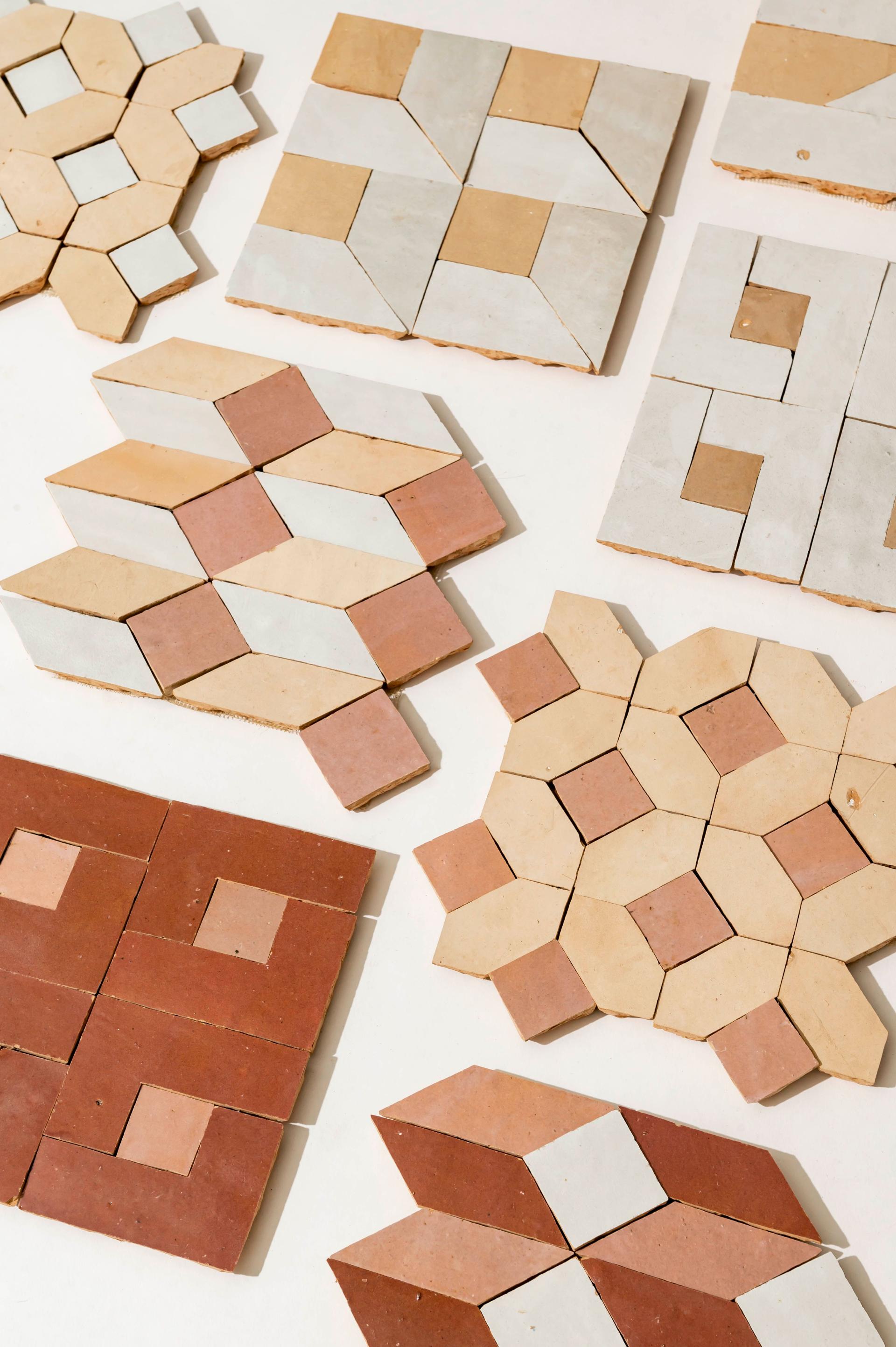 Vibrant geometric zellige tile designs in earthy tones, showcasing a modern take on traditional mosaic patterns.