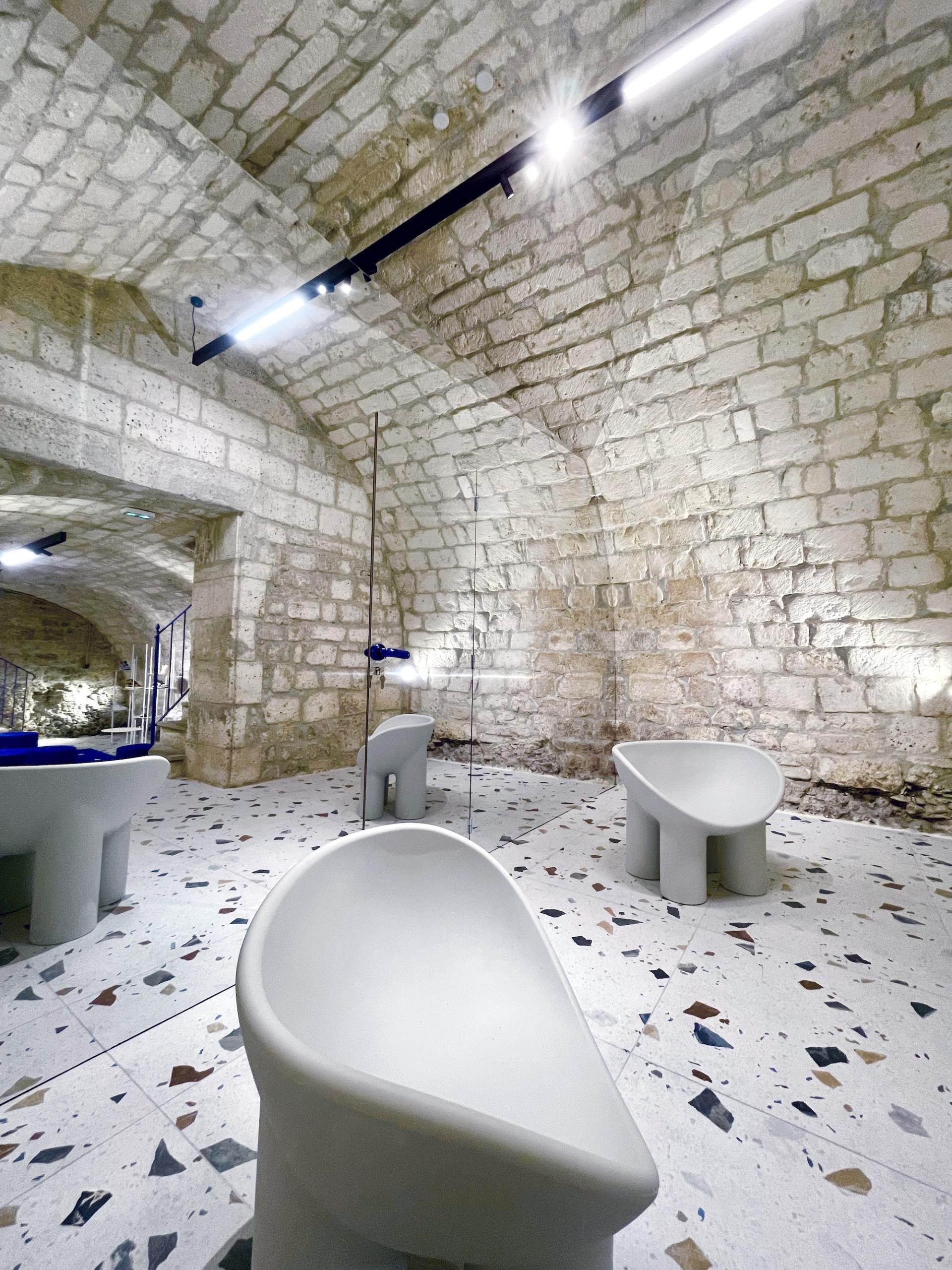 Futuristic seating with electric blue accents in a stylish concept store showcasing Brudey Sneakers in Angoulême, France.