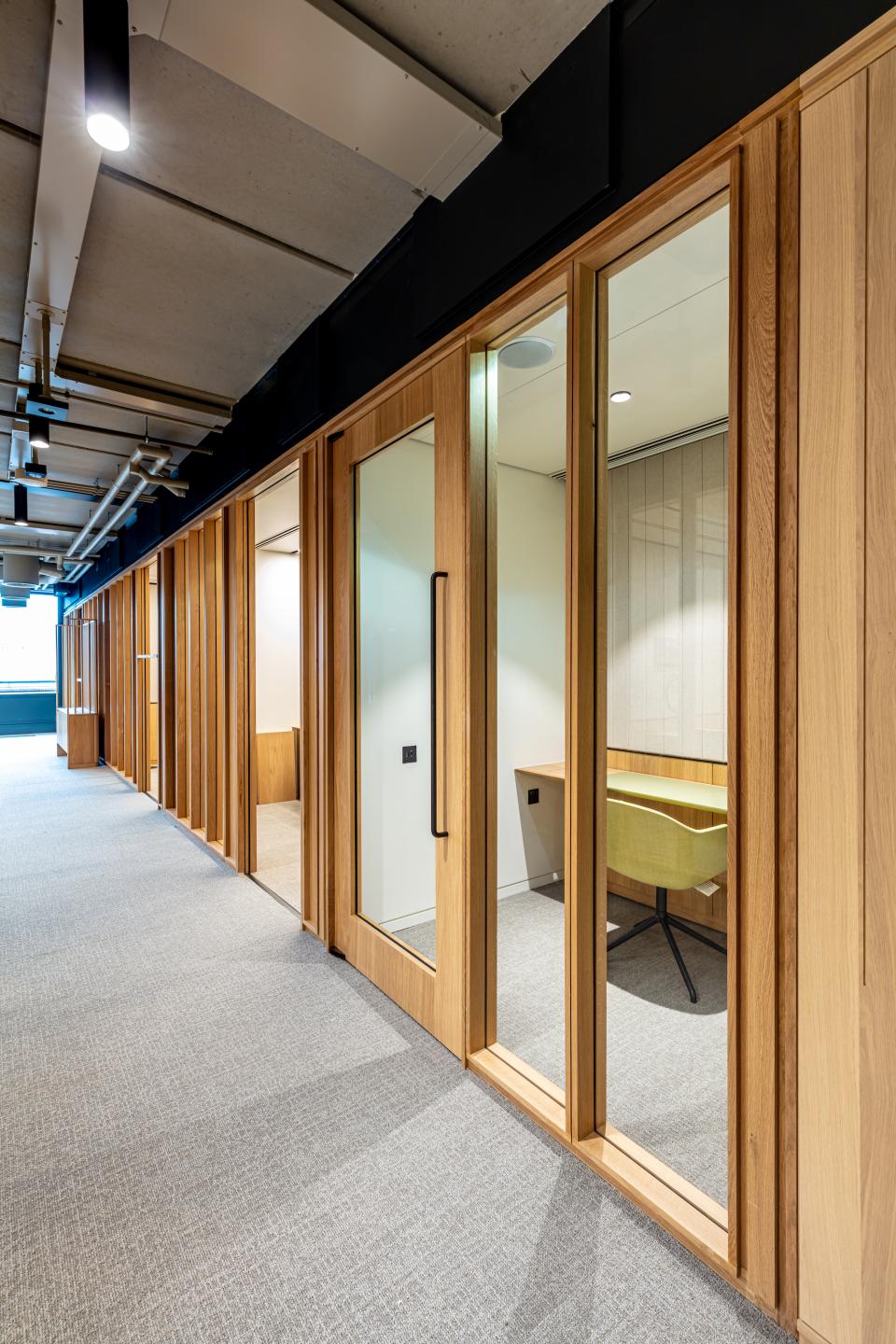 Bespoke timber framed glazed partitions in modern office layout designed for Boston Consulting Group's new London location.