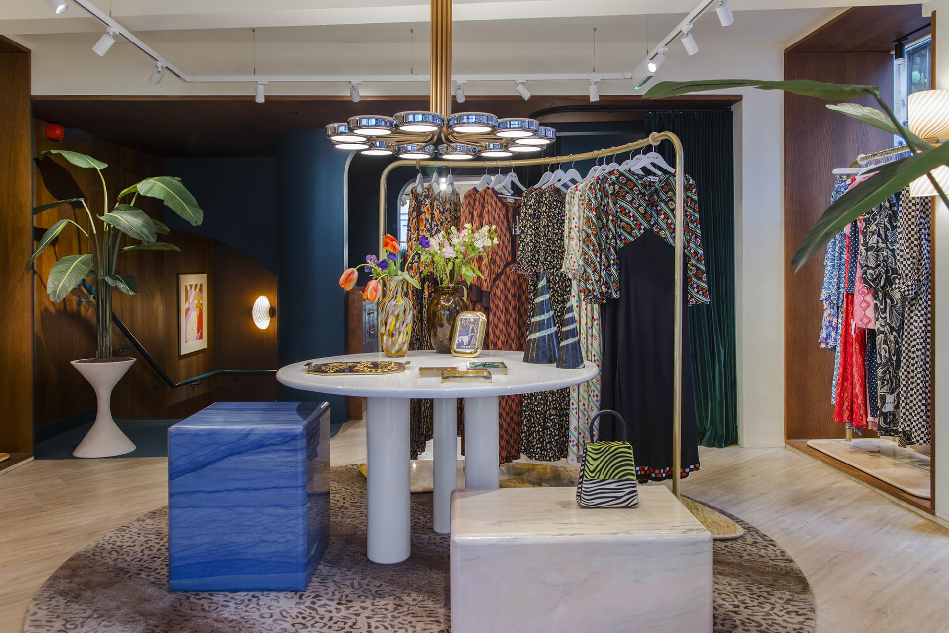 Stylish RIXO Carnaby store interior showcasing vintage fashion and Karndean’s Pearl Oak flooring, with vibrant decor and accessories.